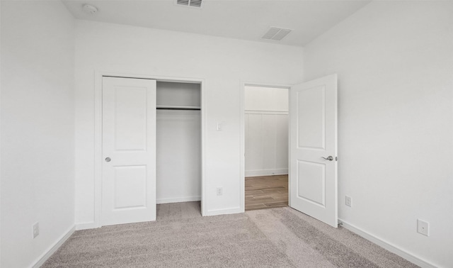 unfurnished bedroom with light carpet