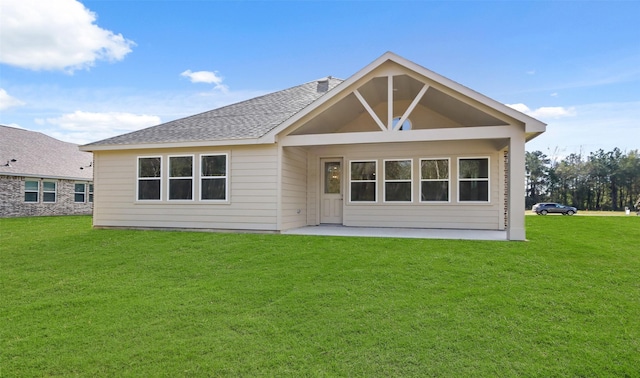 back of house featuring a lawn and a patio