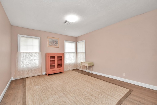 spare room with light wood-type flooring