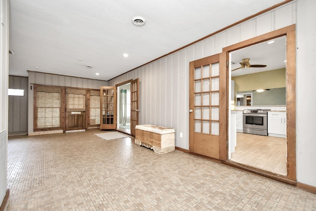 interior space featuring crown molding and ceiling fan