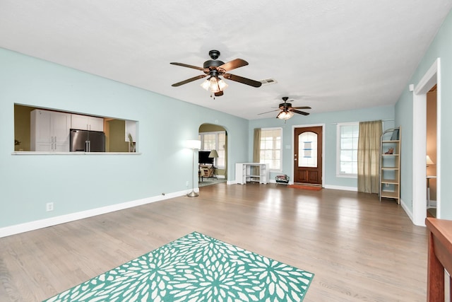 living room with ceiling fan and light hardwood / wood-style flooring