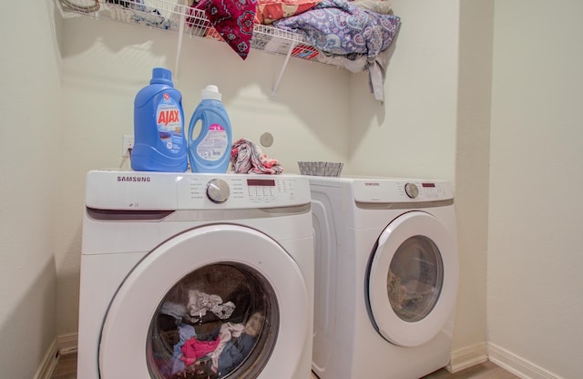 washroom featuring washer and clothes dryer and wood-type flooring