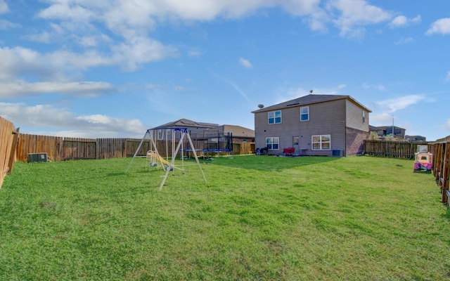 view of yard with a playground and a trampoline