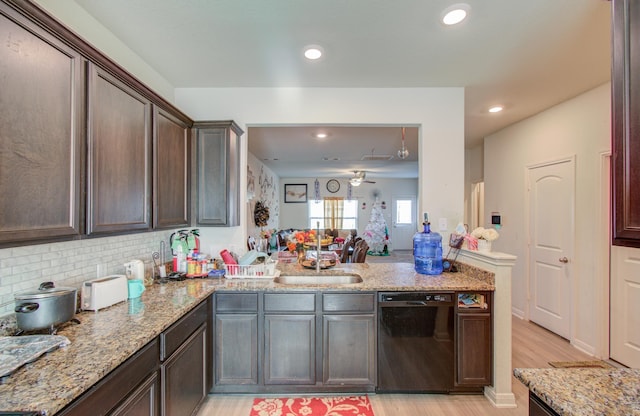 kitchen featuring sink, black dishwasher, dark brown cabinetry, light stone counters, and tasteful backsplash