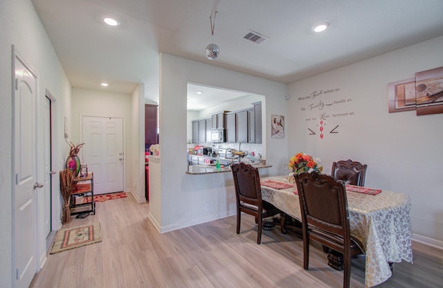 dining room with light wood-type flooring