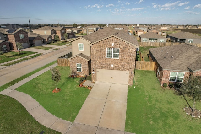 view of front of home with a garage and a front lawn