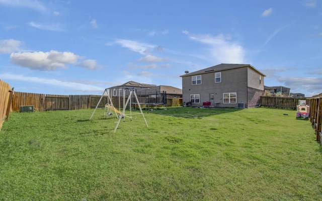 view of yard with a playground and a trampoline