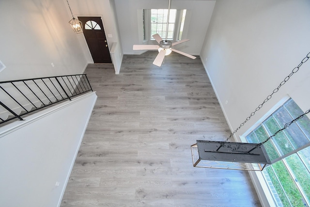 foyer entrance with light hardwood / wood-style flooring and ceiling fan