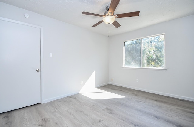 spare room with ceiling fan and light hardwood / wood-style flooring