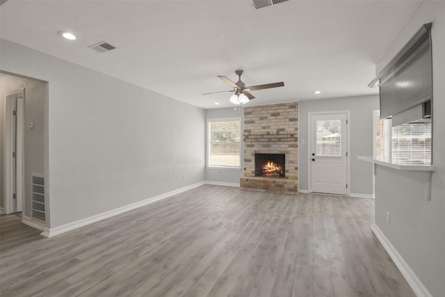 unfurnished living room with ceiling fan, a fireplace, and hardwood / wood-style floors