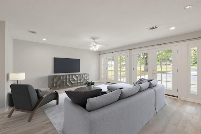 living room featuring french doors and light hardwood / wood-style floors