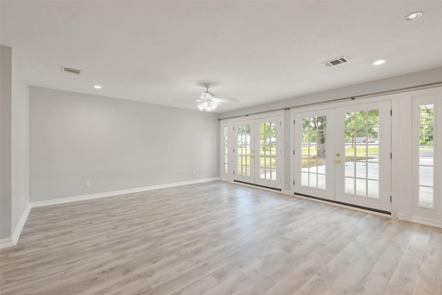 spare room featuring a wealth of natural light, light hardwood / wood-style floors, french doors, and ceiling fan