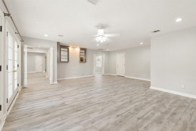 unfurnished living room with ceiling fan and light hardwood / wood-style flooring