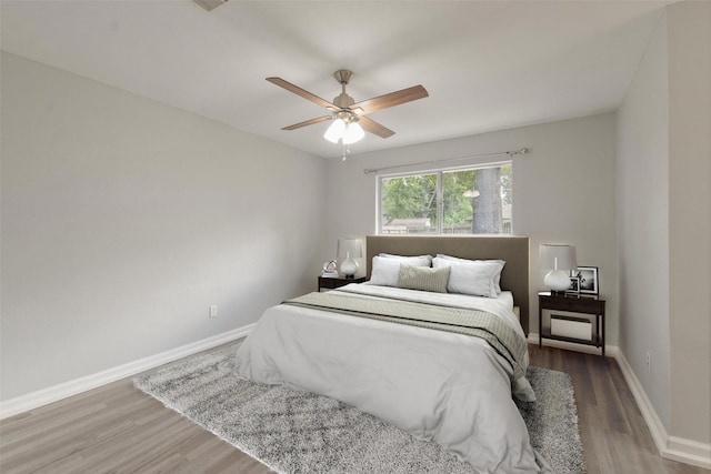 bedroom with wood-type flooring and ceiling fan