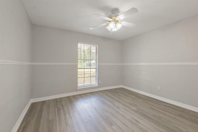 spare room with hardwood / wood-style flooring and ceiling fan