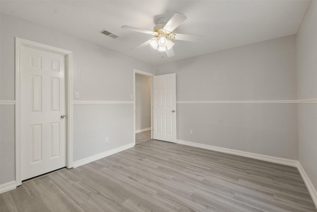 unfurnished room with ceiling fan and light wood-type flooring