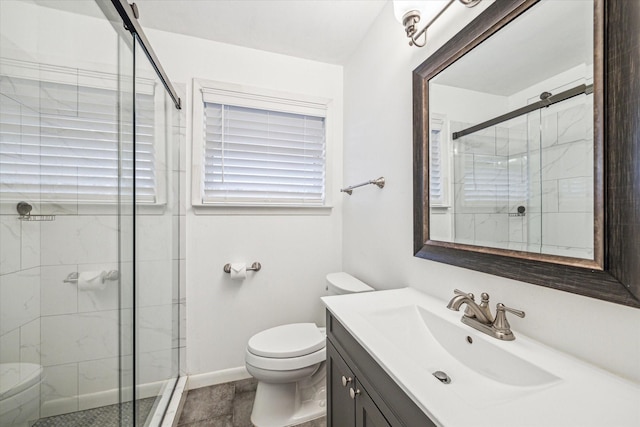 bathroom featuring walk in shower, vanity, and toilet