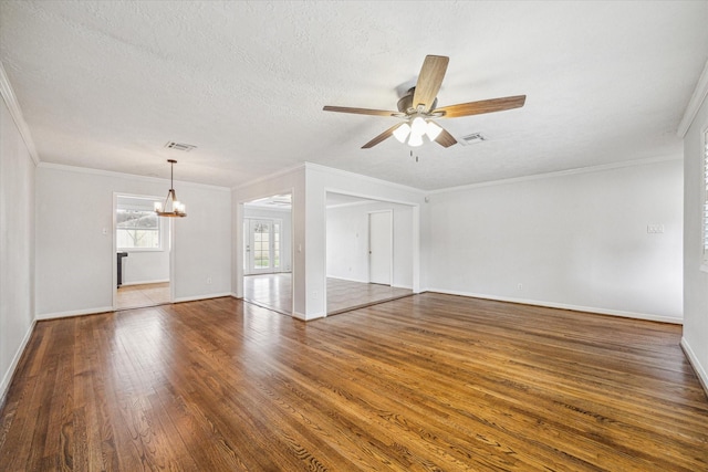 unfurnished living room featuring ornamental molding, dark hardwood / wood-style floors, ceiling fan with notable chandelier, and a textured ceiling