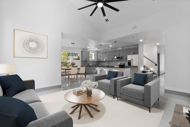 living room featuring ceiling fan, sink, and high vaulted ceiling