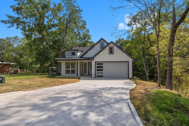 view of front of house featuring a porch, a garage, and a front lawn