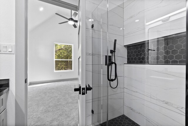 bathroom featuring vaulted ceiling, tiled shower, and ceiling fan