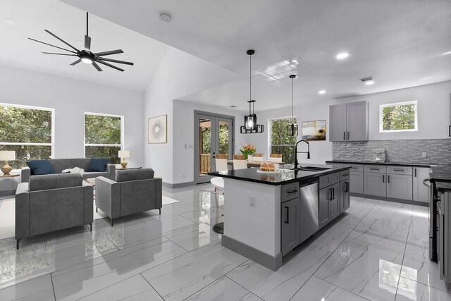 kitchen featuring gray cabinets, pendant lighting, dishwasher, sink, and a center island with sink