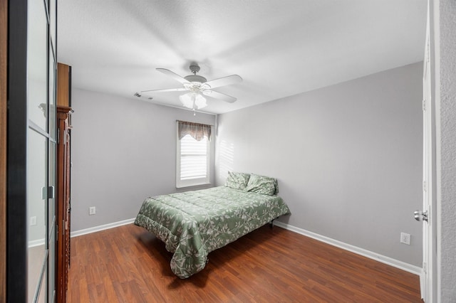 bedroom featuring dark hardwood / wood-style floors and ceiling fan