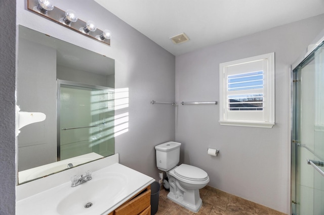 bathroom featuring walk in shower, vanity, and toilet