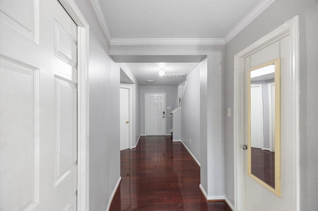 hall featuring ornamental molding and dark hardwood / wood-style floors