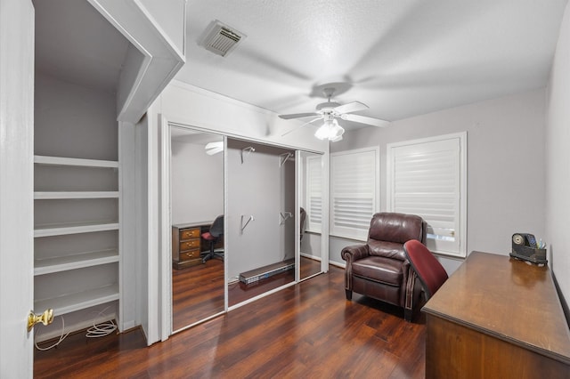 office space with dark wood-type flooring and ceiling fan