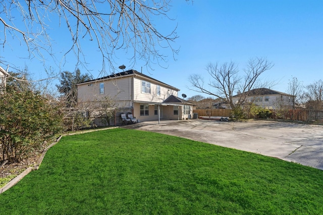 back of house featuring a yard and a patio area