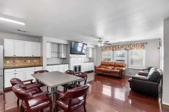 dining space featuring ceiling fan and dark hardwood / wood-style floors