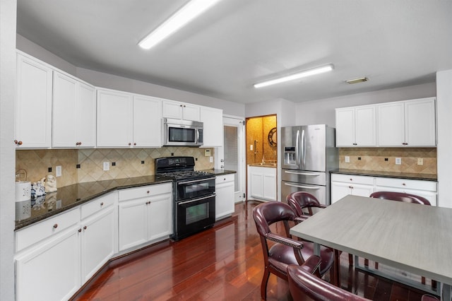 kitchen featuring tasteful backsplash, stainless steel appliances, dark hardwood / wood-style floors, and white cabinets