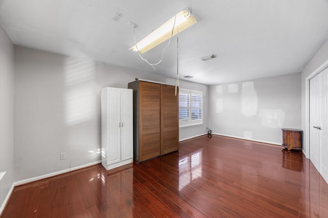 unfurnished bedroom featuring dark wood-type flooring