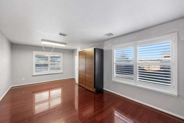 spare room featuring dark hardwood / wood-style flooring