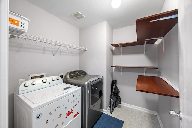 laundry room with washing machine and dryer