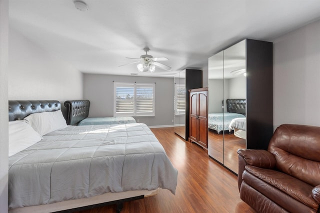 bedroom with ceiling fan and light hardwood / wood-style floors