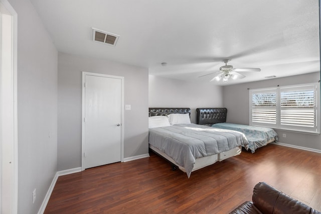 bedroom with dark wood-type flooring and ceiling fan