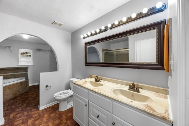 full bathroom featuring toilet, shower with separate bathtub, a textured ceiling, parquet floors, and vanity