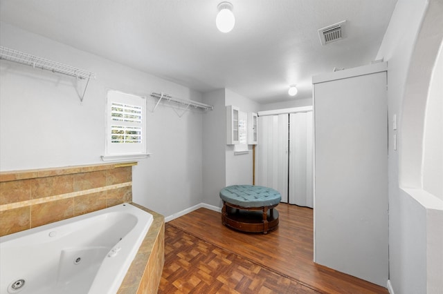 bathroom with tiled bath