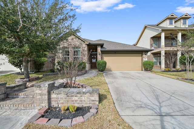 view of front of property featuring a balcony and a garage