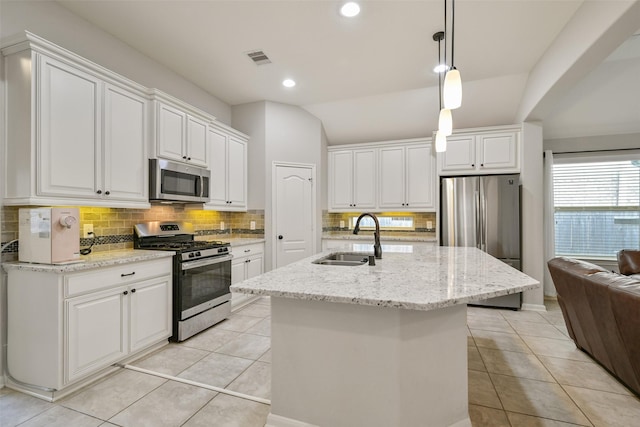 kitchen with white cabinetry, an island with sink, appliances with stainless steel finishes, and sink