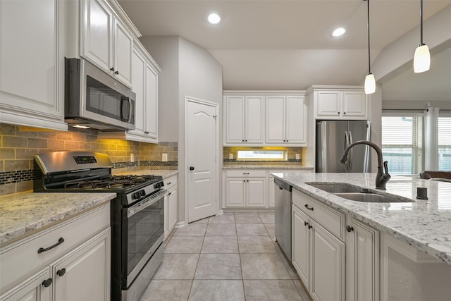 kitchen featuring appliances with stainless steel finishes, sink, pendant lighting, and white cabinets