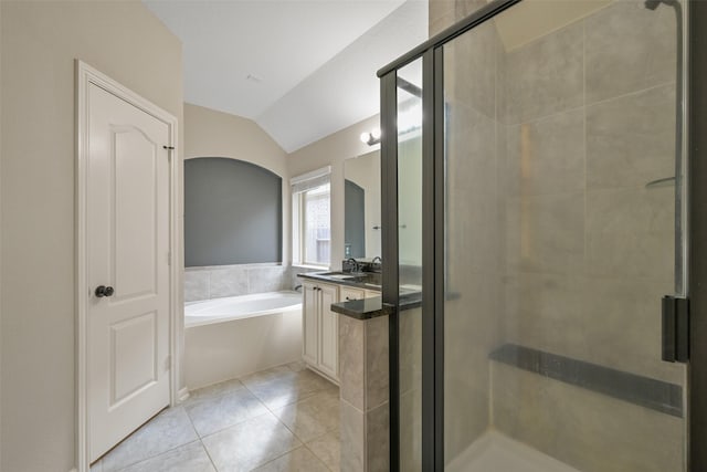 bathroom featuring tile patterned flooring, sink, vaulted ceiling, and independent shower and bath