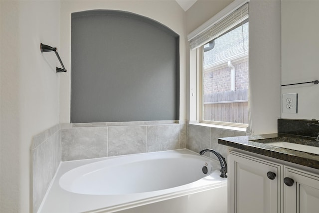 bathroom with vanity and a tub