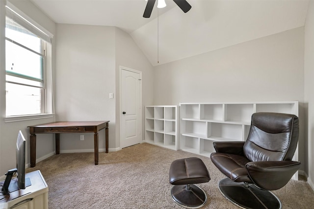 sitting room with vaulted ceiling, light colored carpet, and ceiling fan