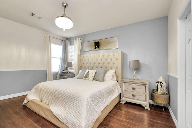 bedroom with dark hardwood / wood-style floors