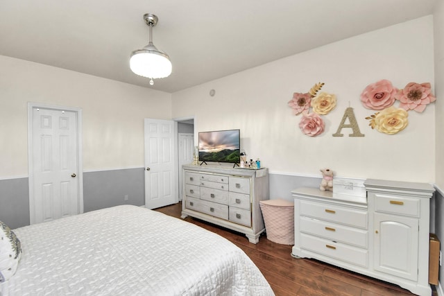 bedroom with dark hardwood / wood-style flooring