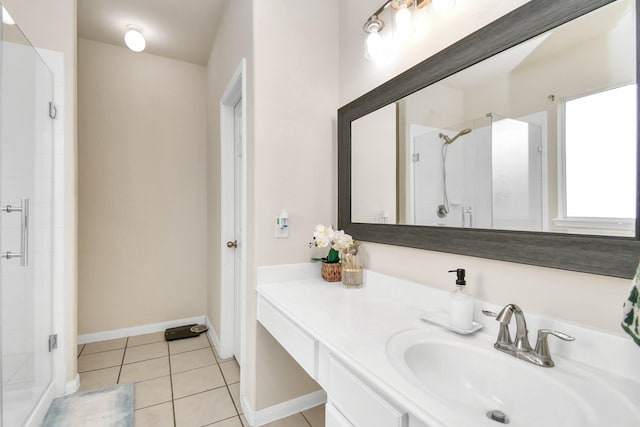 bathroom featuring tile patterned flooring, vanity, and walk in shower