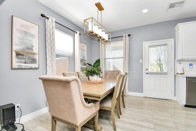 dining space featuring a notable chandelier